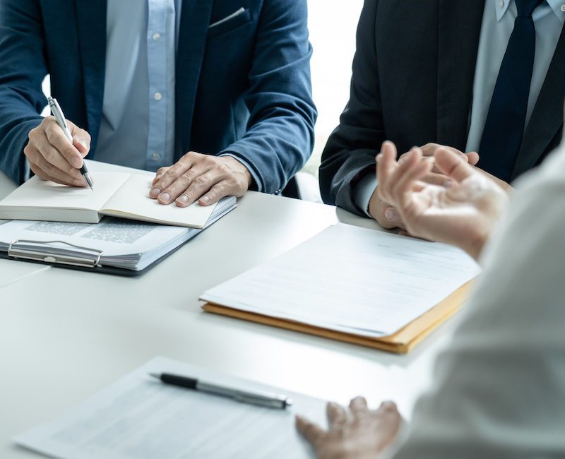 Businesspeople and Male lawyer consult and conference having team meeting with the client at a law firm in office, Law and Legal services concept.